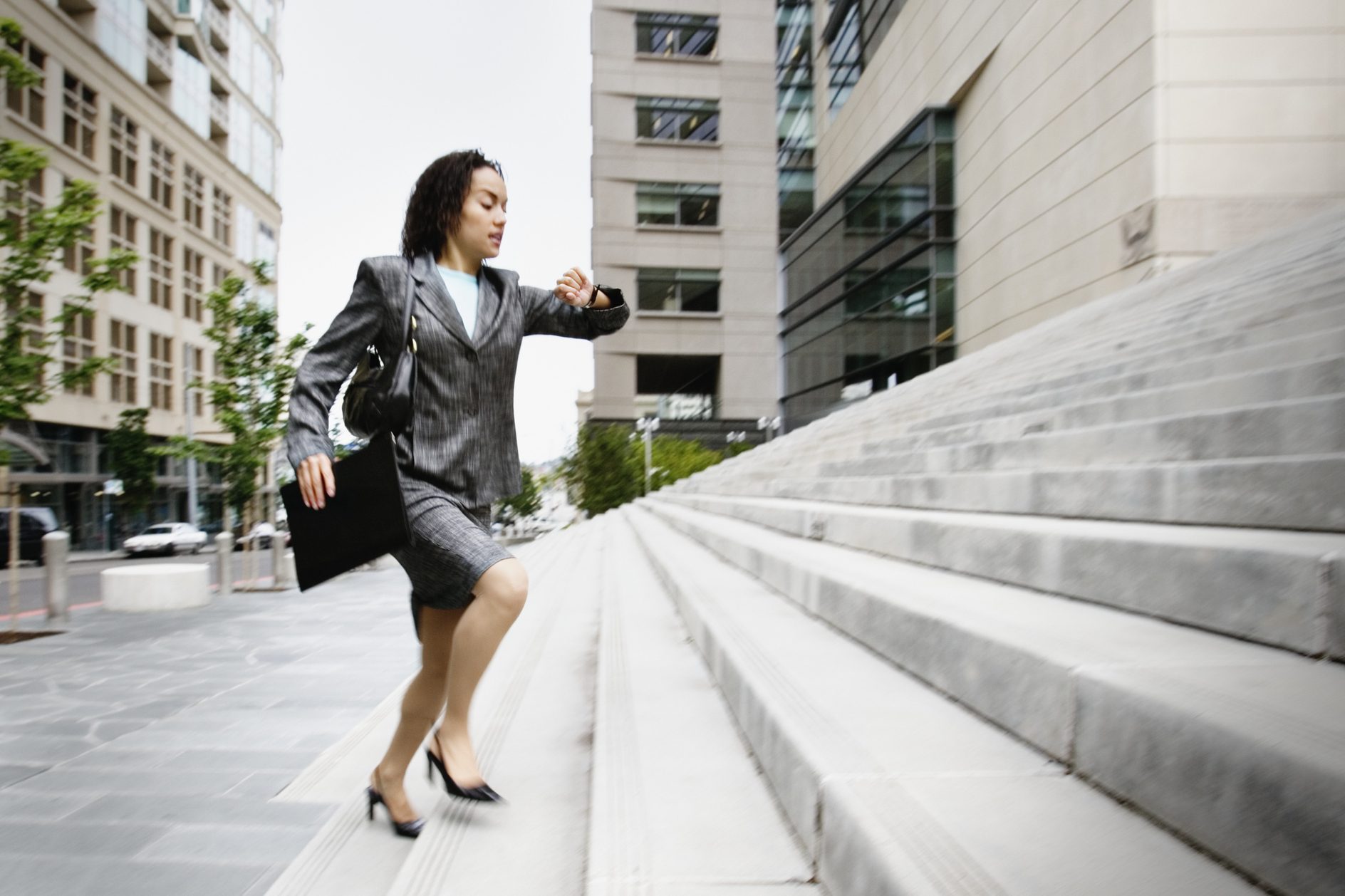Businesswoman running up steps
