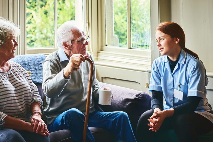 Female Medic Visiting Elderly Couple At Home