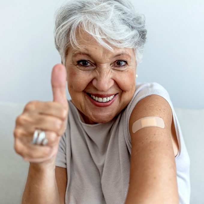 woman with vaccine smiling
