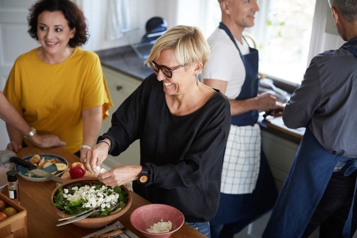 woman making salad for a party