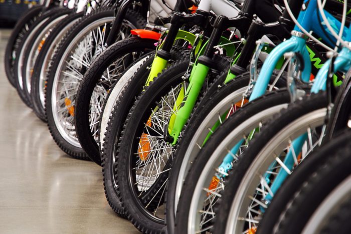 Many bicycles in sports store, seasonal sale