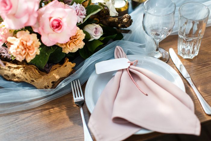 Wedding table decoration with glasses and pink napkins