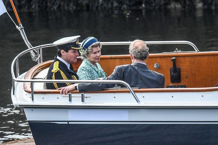 Imelda Staunton and other cast members seen on boat on the set of Netflix's The Crown