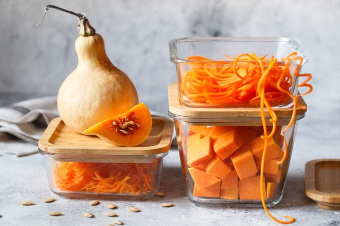 Glass boxes with fresh raw orange vegetables. Finaly shredded pumpkin and big pieces. Healthy Meal Prep, recipe preparation photos. Healthy vegan dishes in glass containers. Weight loss food concept