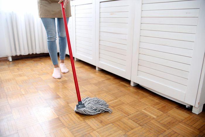 Young woman cleaning a floor
