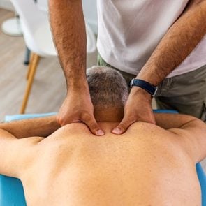 Man enjoying therapeutic neck massage in spa