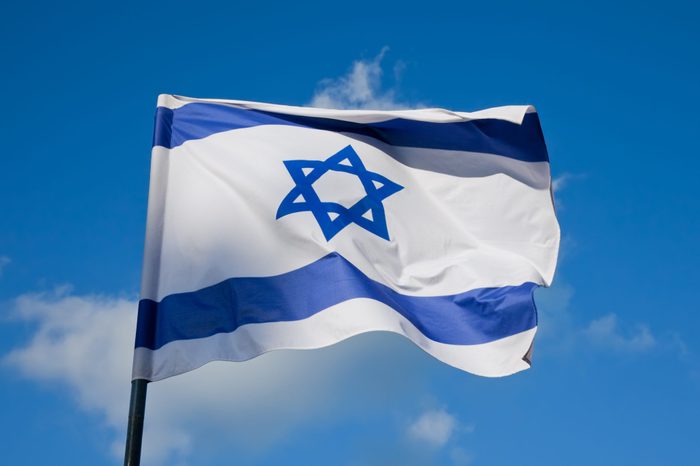 Israeli flag flying on a flagpole
