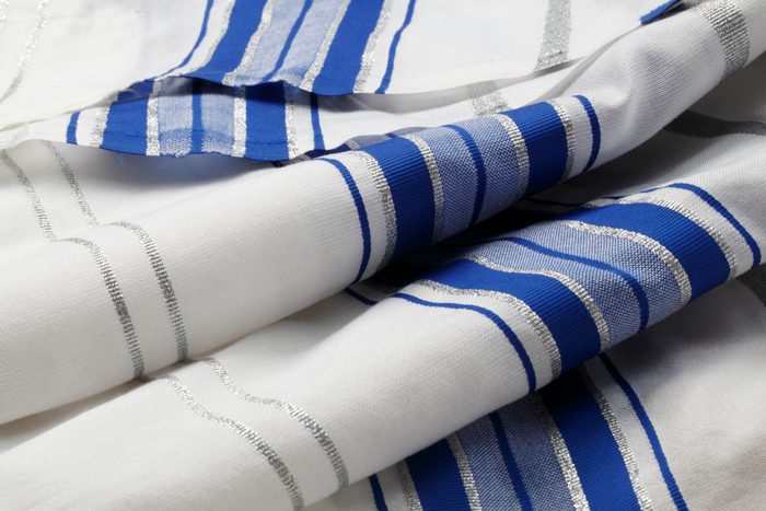 Blue, silver and white striped Tallit folded in rolls