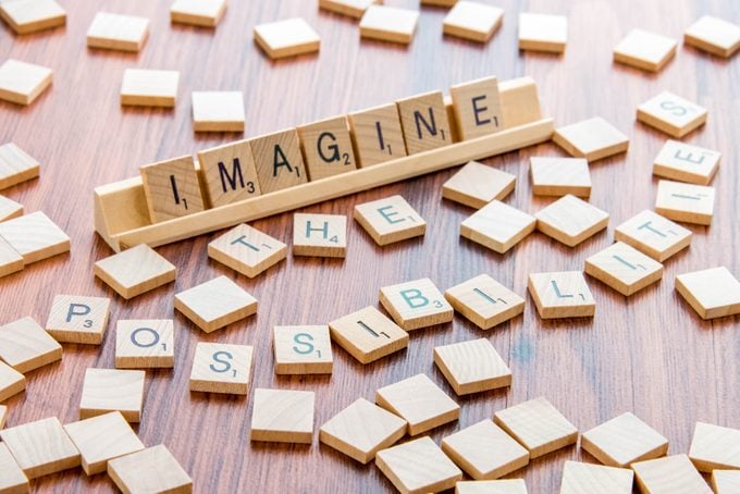 Scrabble Word Game wood tiles spelling IMAGINE THE POSSIBILITIES