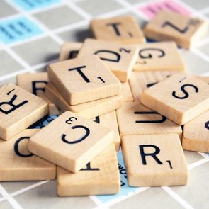 Scrabble Letters scattered on top of game board