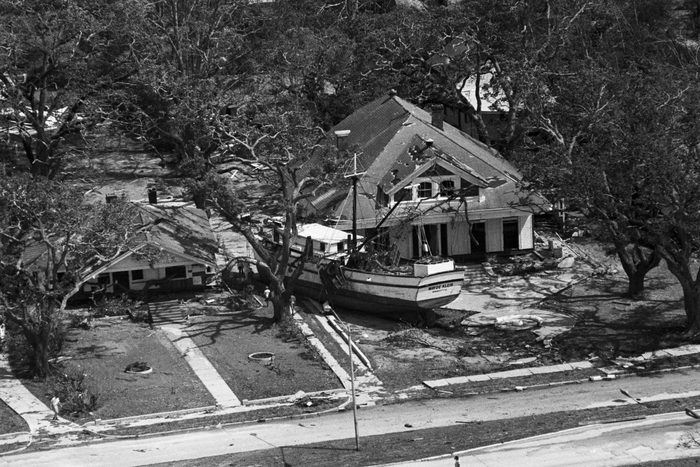 Boat Rests Against A House Aft Hurricane after hurricane Camille