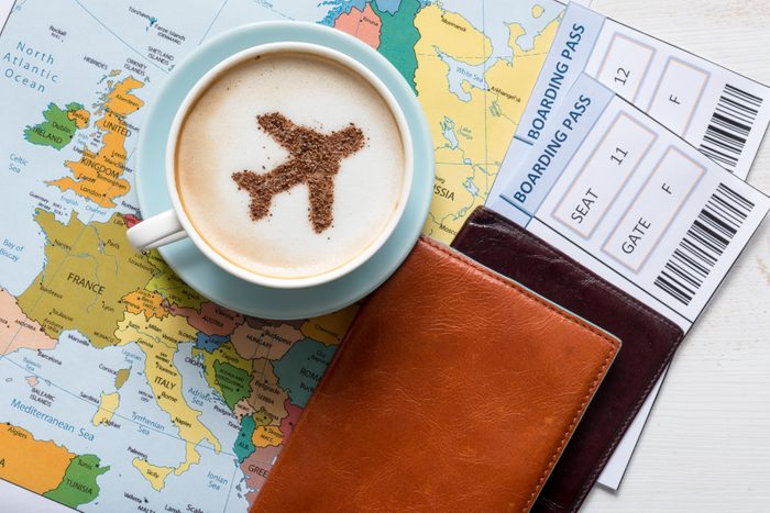 Airplane made of cinnamon in cappuccino, Passports and Europe map