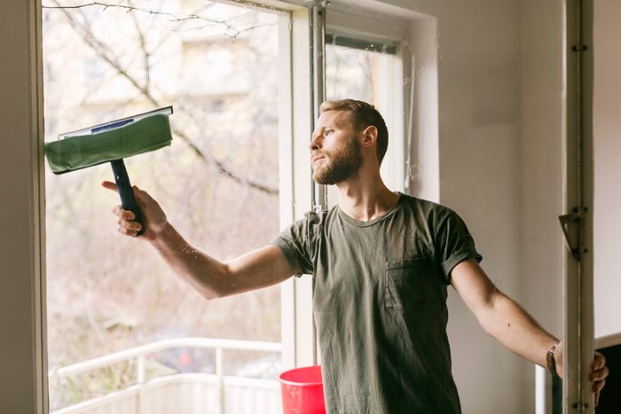 Man cleaning glass window