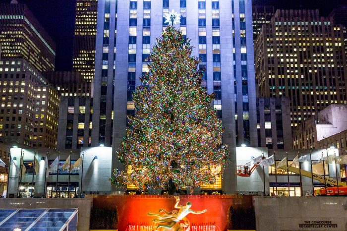 Brightly illuminated Rockefeller Plaza ice skating rink and christmas tree during the holiday season in new york city