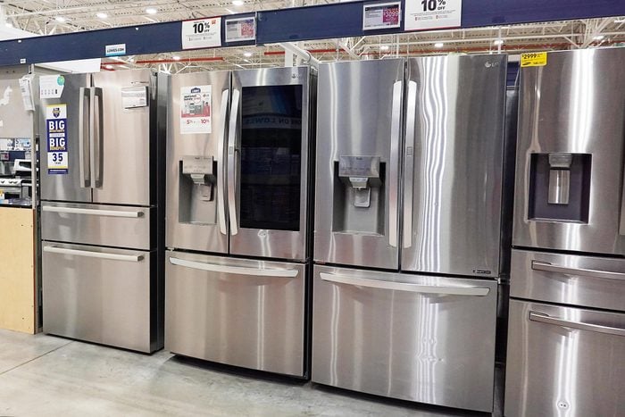 a row of refrigerators for sale at Lowe's