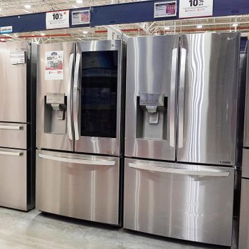 a row of refrigerators for sale at Lowe's