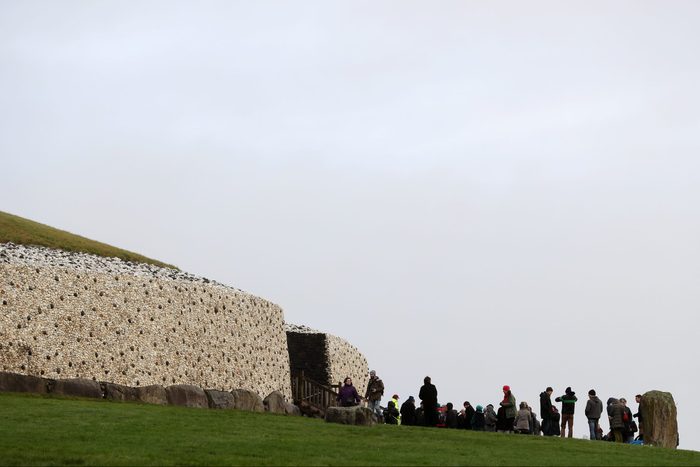 People gather for sunrise at Newgrange on the morning of the winter solstice, which is marked by pagan celebrations.