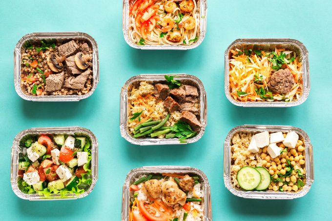 weekly meals planned out into separate containers on a turquoise background