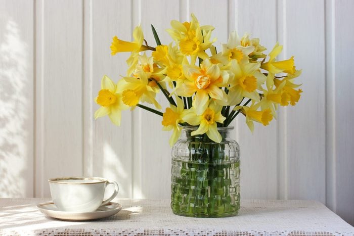 bouquet of yellow daffodils in a glass vase