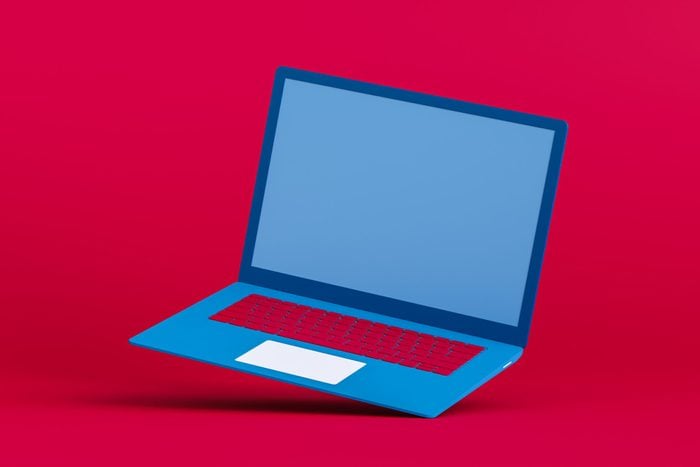 Red and Blue color Laptop Flying on red background