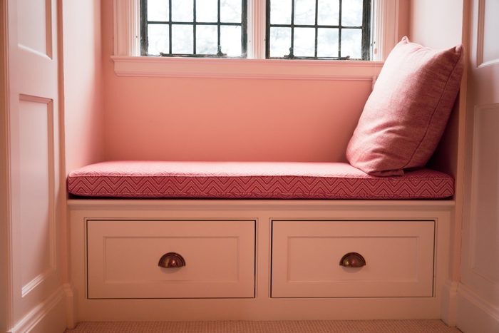 shades of pink: leaded glass windows above window seat in pink playroom in tutor home