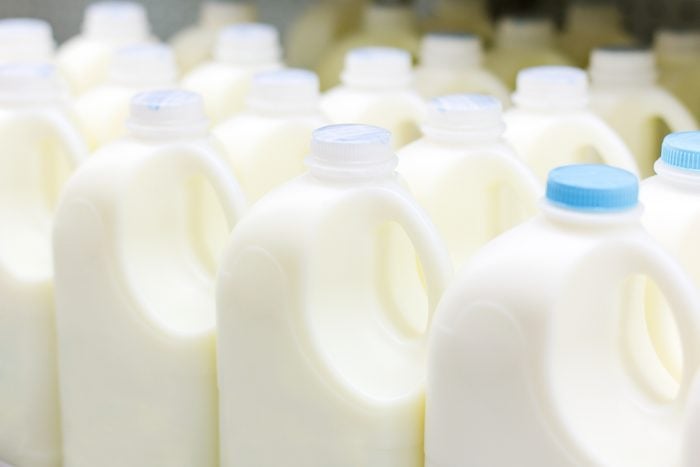 Plastic bottles of milk in a grocery store refridgerator