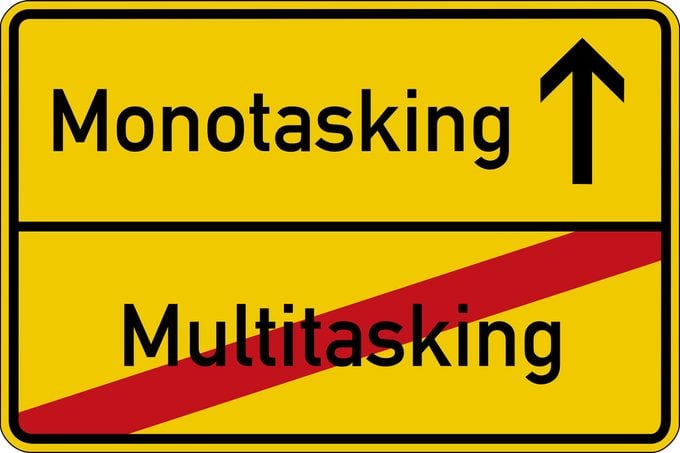 Multitasking And Monotasking on a road sign