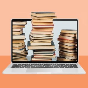 laptop on an orange background with stacks of books coming out of the screen
