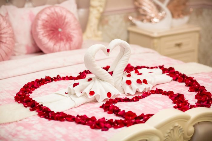 two towel swans shaped on the bed,Honey moon bed.Honeymoon