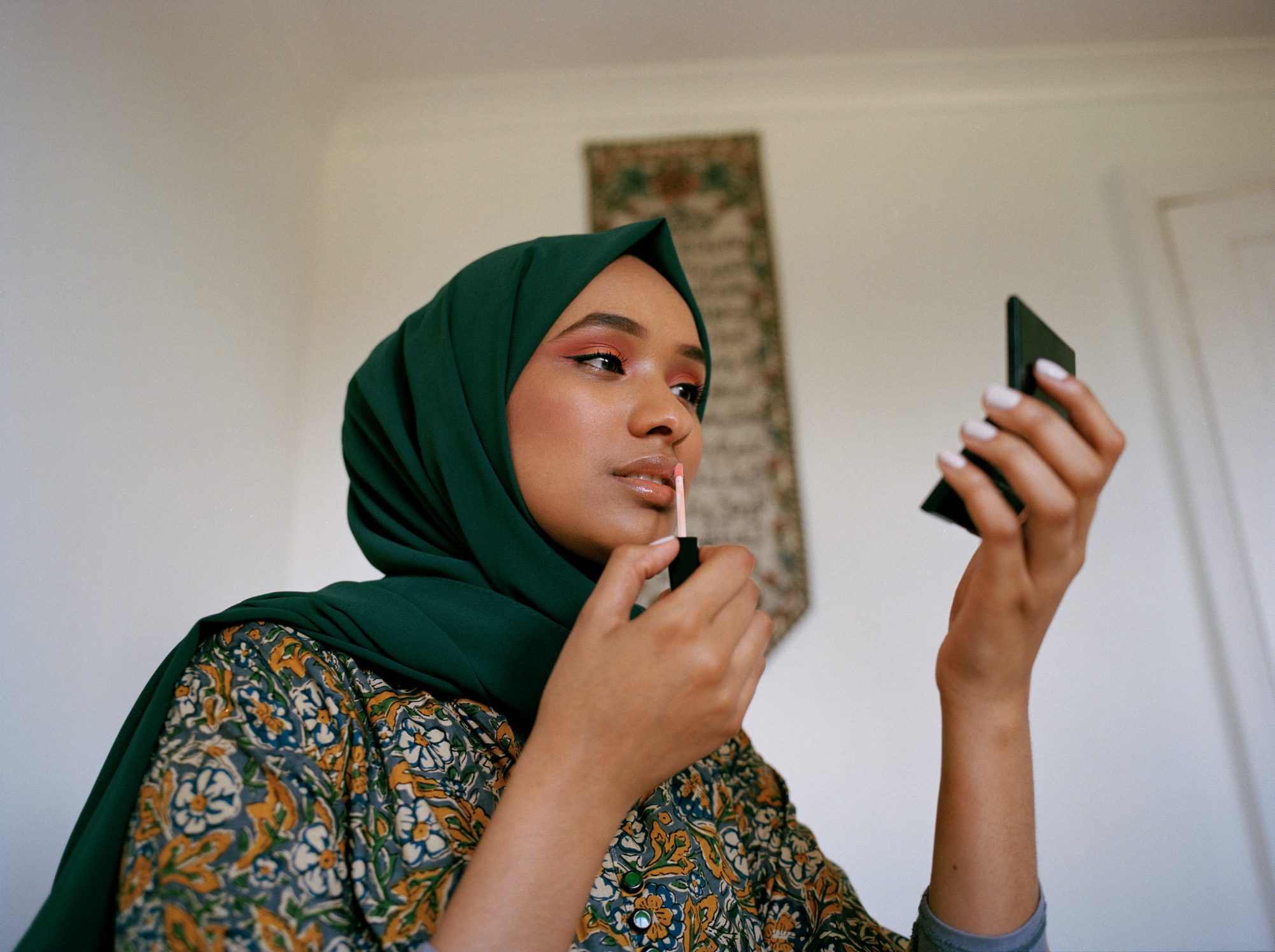 Portrait of young muslim woman applying make up