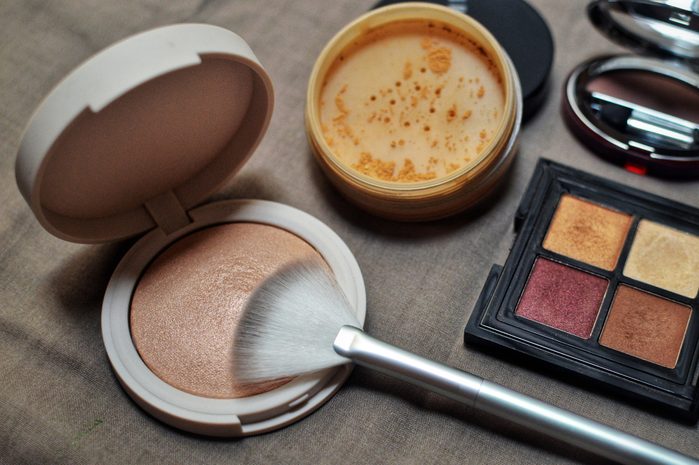 make-up products - highlighter, loose powder, and eyeshadow
