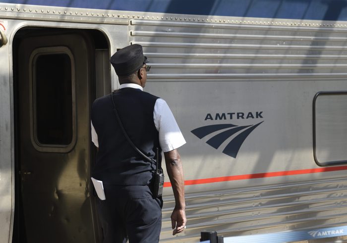 Amtrak conductor prepares for departure from train station