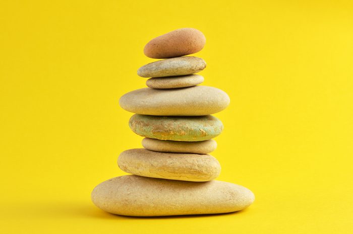 Stack Of Stones Against Yellow Background