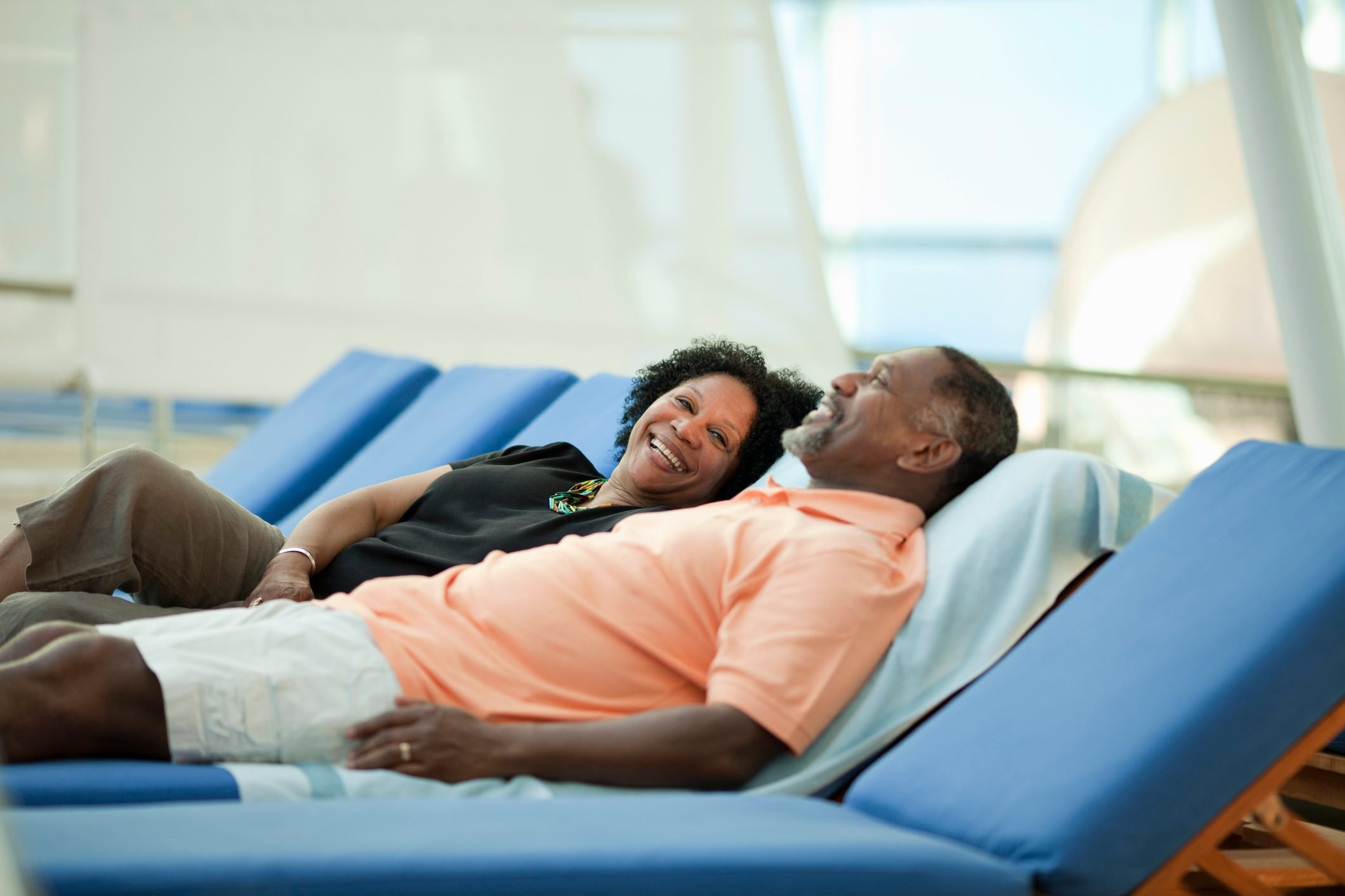 Mature couple on lounge chair on cruise ship