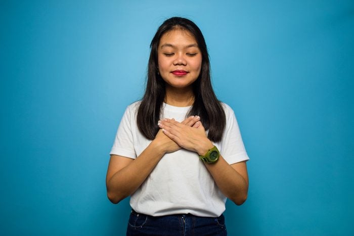 Portrait of Young beautiful asian women using white T-shirt with blue isolated background