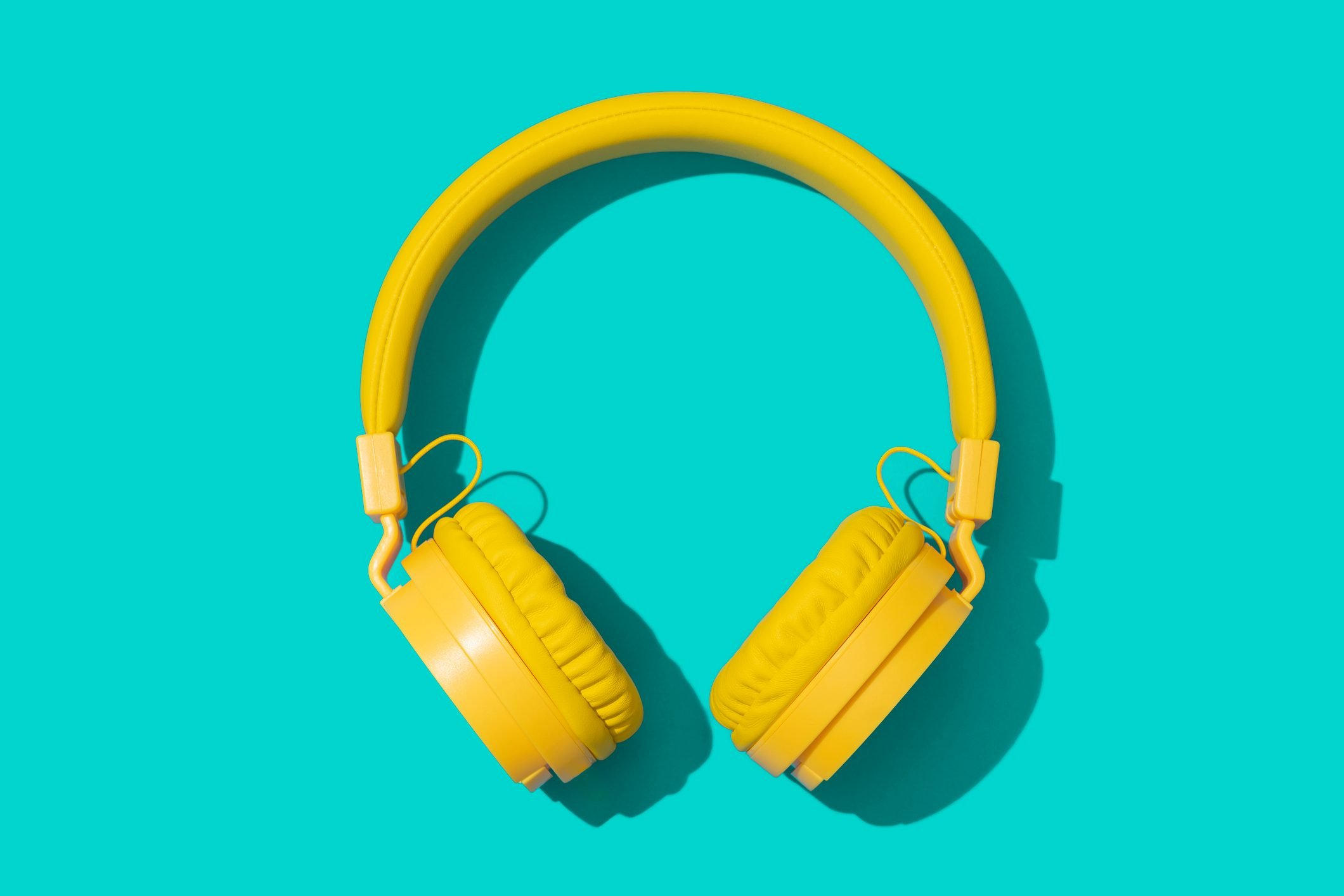 Yellow headphones on a green background