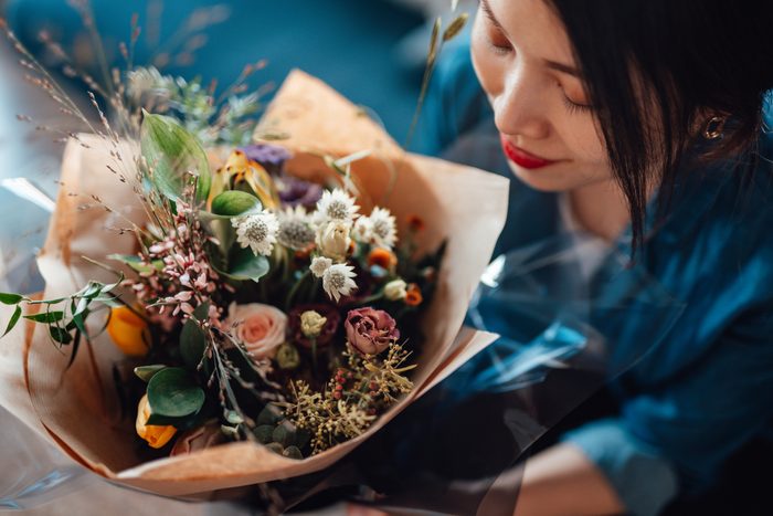 Direct above view of young woman receiving flower bouquet