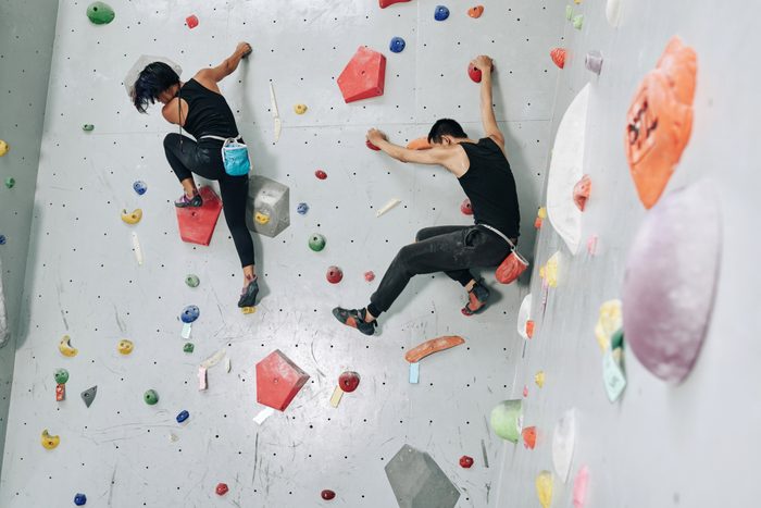 Young Couple Climbing Together