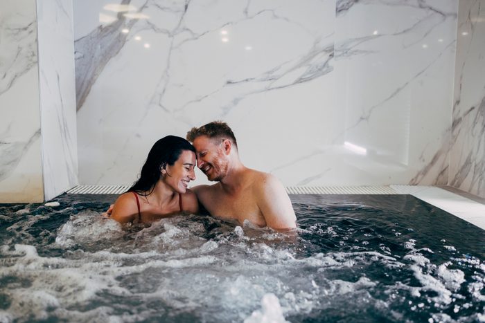 Happy Couple Having Fun in Hot Tub