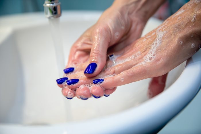 Woman washing hands and nails