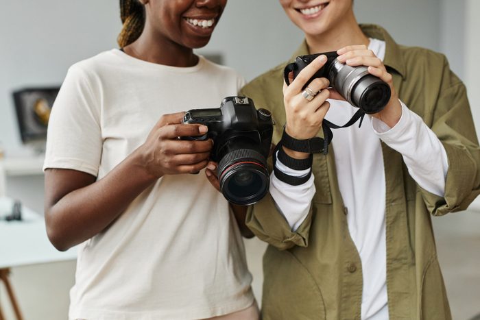 Two Photographers looking at their cameras