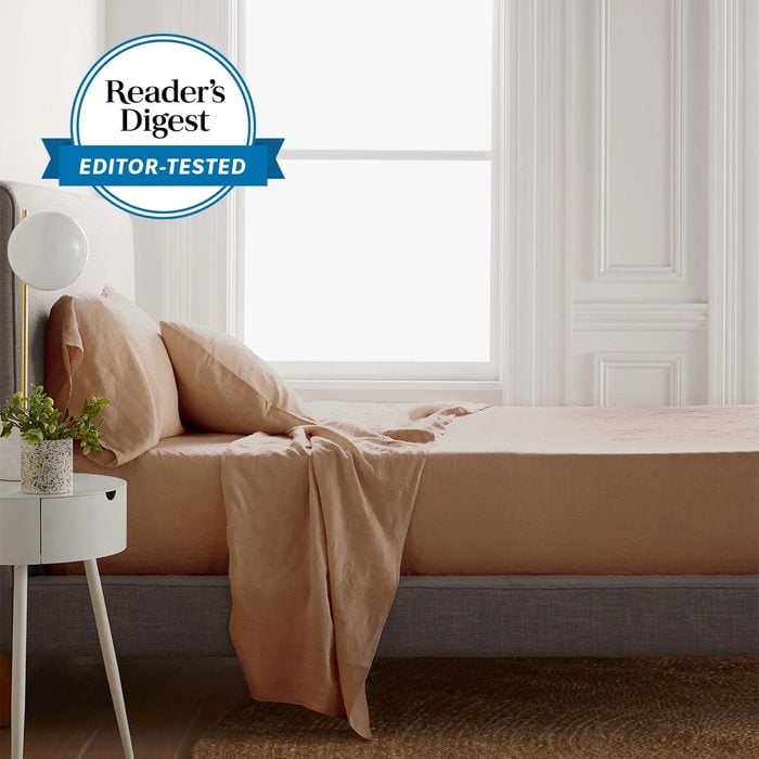desert rose quince linen sheets on a bed with the Reader's Digest Editor tested Badge