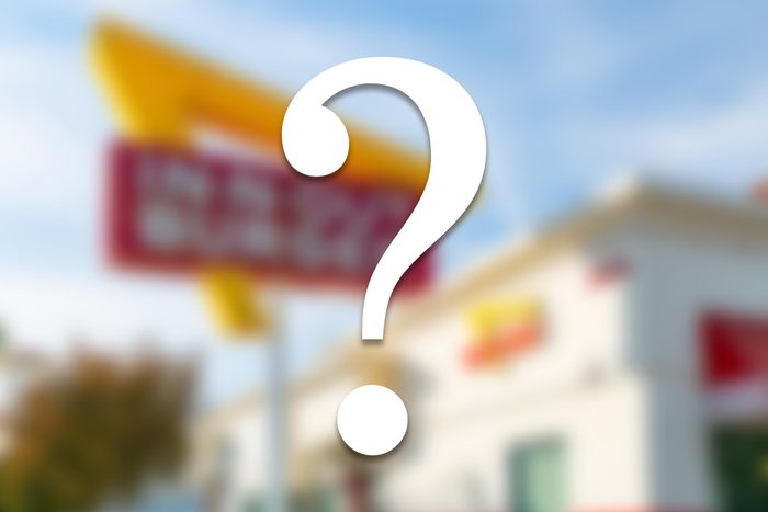 blurred fast food restaurant with a white question mark overlay
