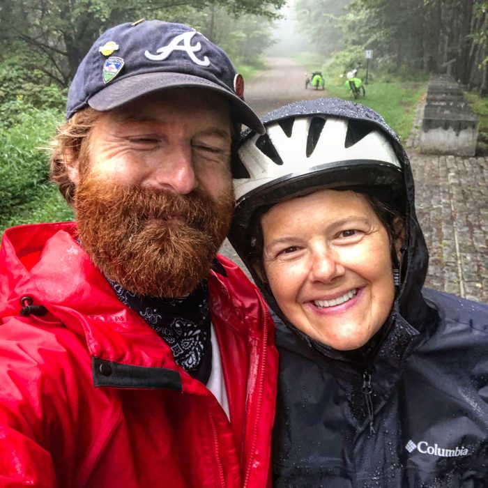 smiling husband and wife in rain coats