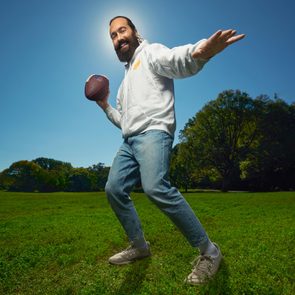 Meir Kalmanson holding a football outdoors