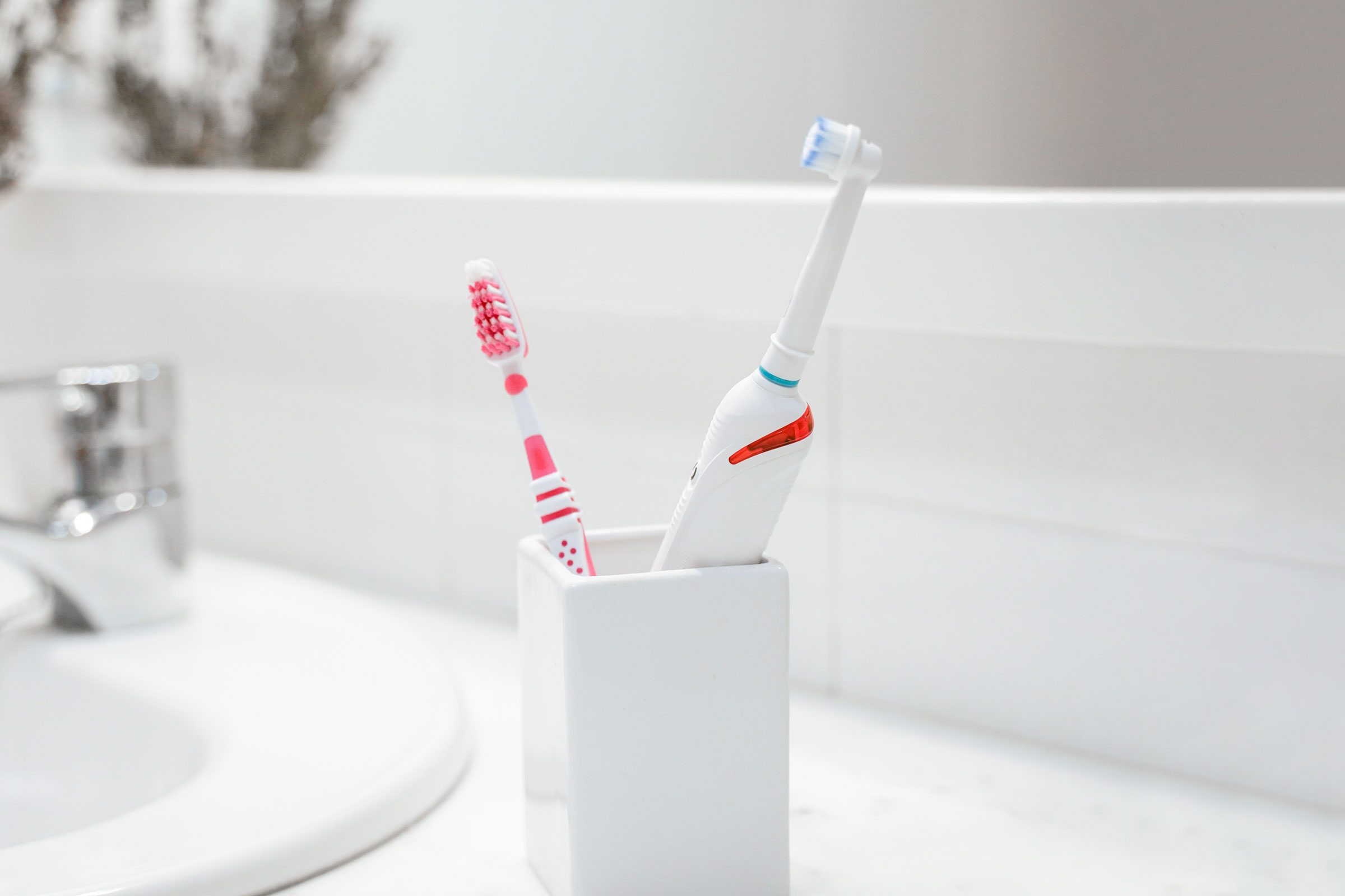 https://www.rd.com/wp-content/uploads/2023/01/two-toothbrushes-in-white-bathroom-GettyImages-1282648003-MLedit.jpg