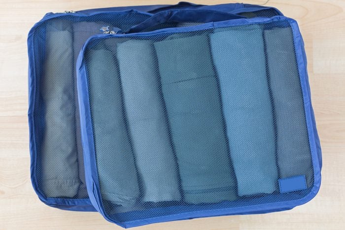 packing cubes packed with rolled clothes for packing a suitcase