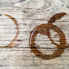 Three water rings on a light wooden surface