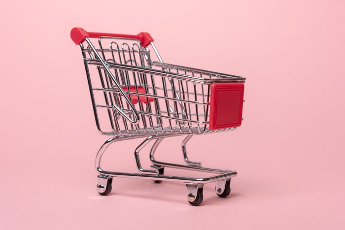 Close-Up Of Shopping Cart Against Pink Background