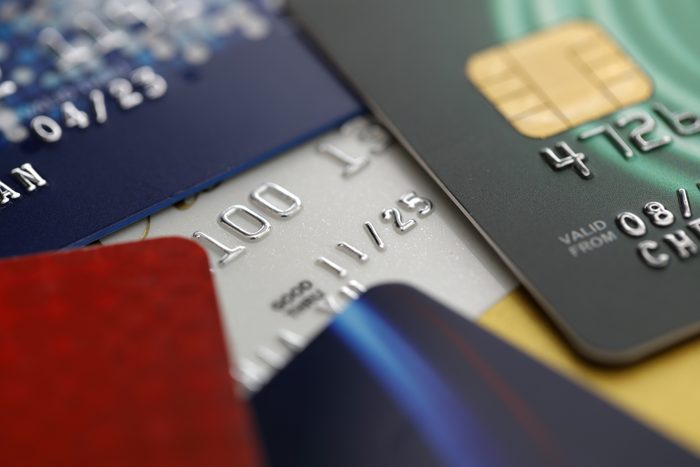 Stack of multicolored credit cards on a black background